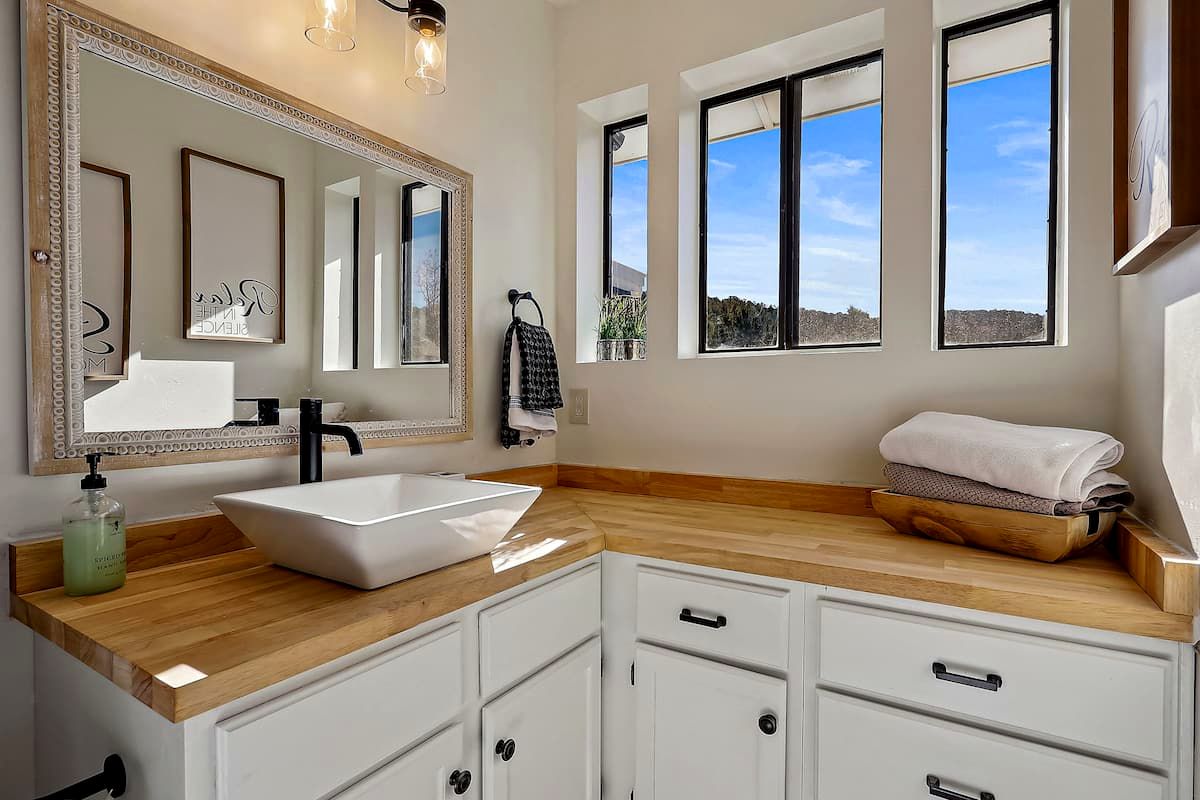 Renovated bathroom with butcher-block vanity and vessel sink