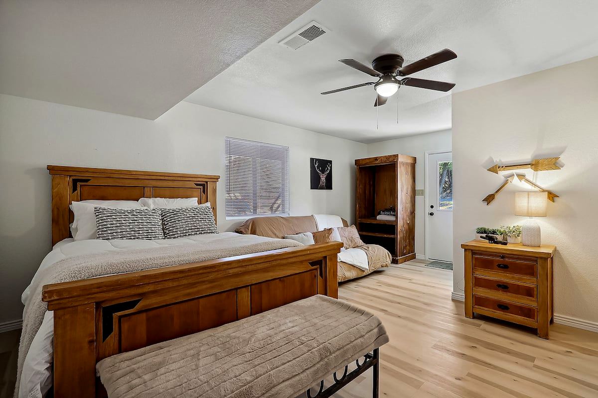 Downstairs bedroom with queen bed and futon