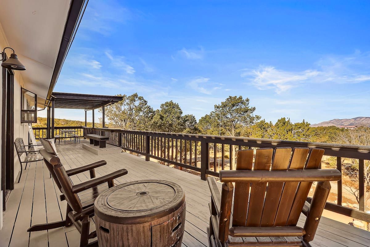 Adirondack chairs on the sunny deck overlooking the pines