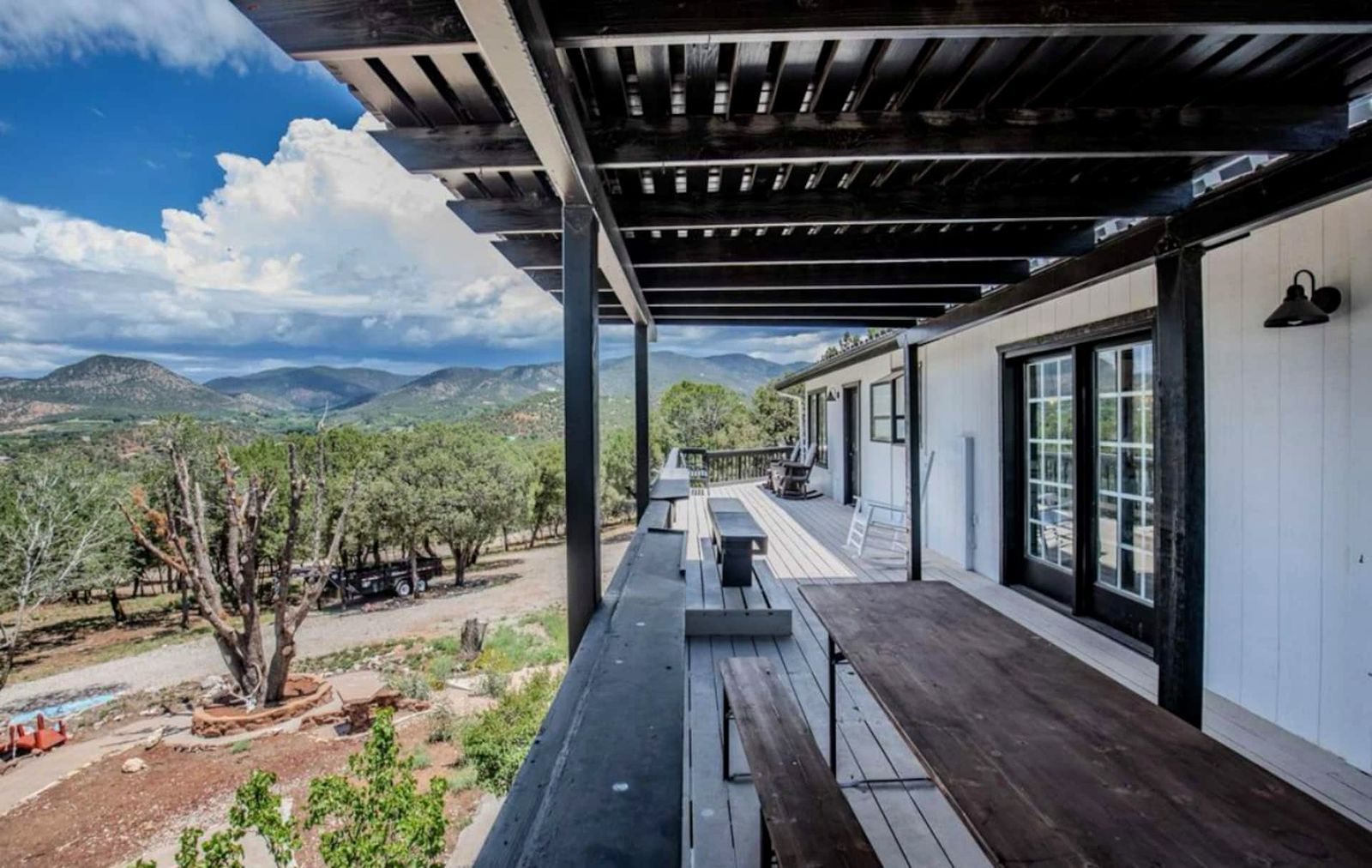 Covered upper deck with long table looking out on the Sacramento Mountains