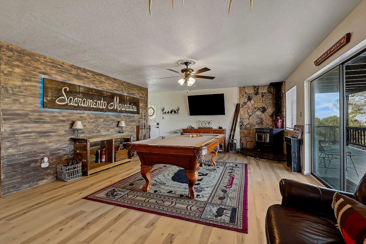 Den with pool table, leather sofas and TV