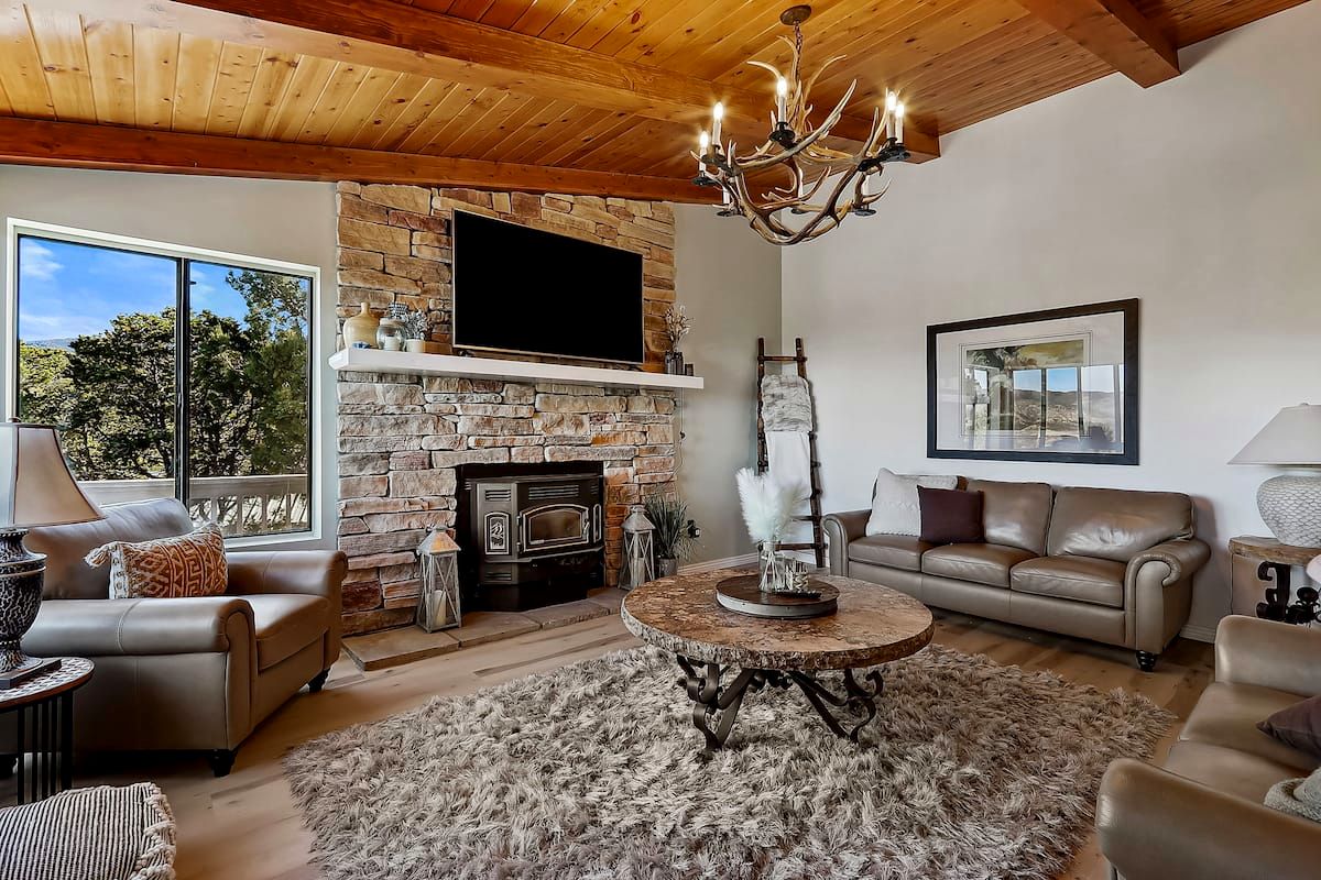 Living room with vaulted wood ceiling and antler chandelier