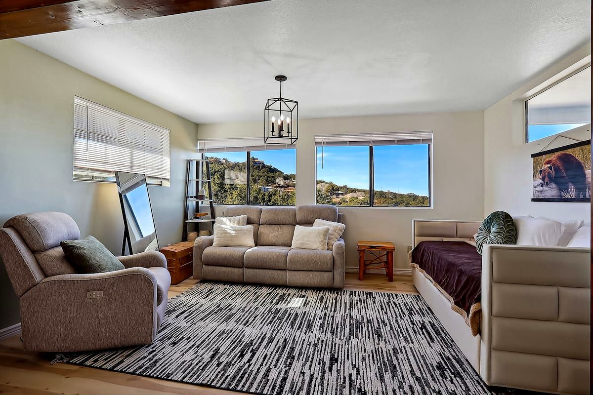 Primary suite sitting area with daybed and big windows