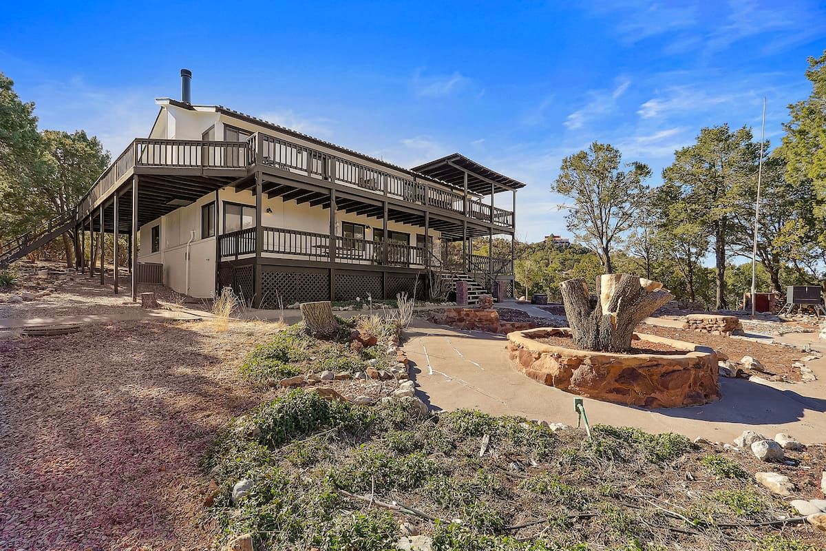 Cabin yard with stone fire pit ring and two-story deck